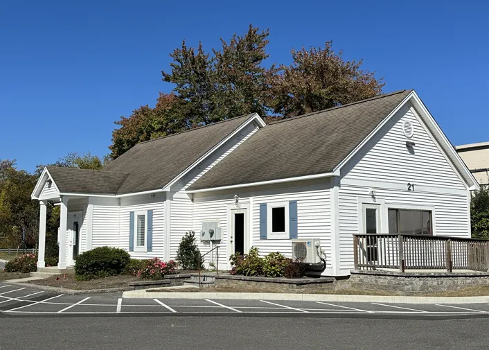 Church exterior at 21 Executive Drive, white siding with parking in front.
